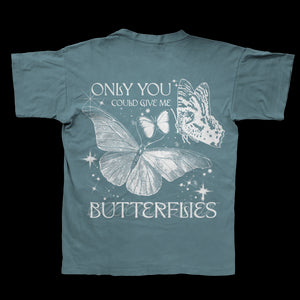 This JVKE Comfort Colors blue t-shirt showcases three butterfly illustrations and the phrase ONLY YOU COULD GIVE ME BUTTERFLIES in white, plus sparkles—perfect for fans of unique printed apparel.